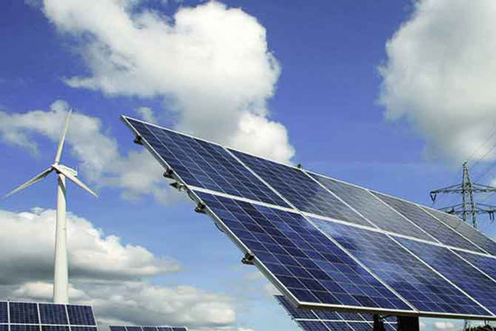 Erneuerbare Energie: Solarzellen und Windrad im Hintergrund